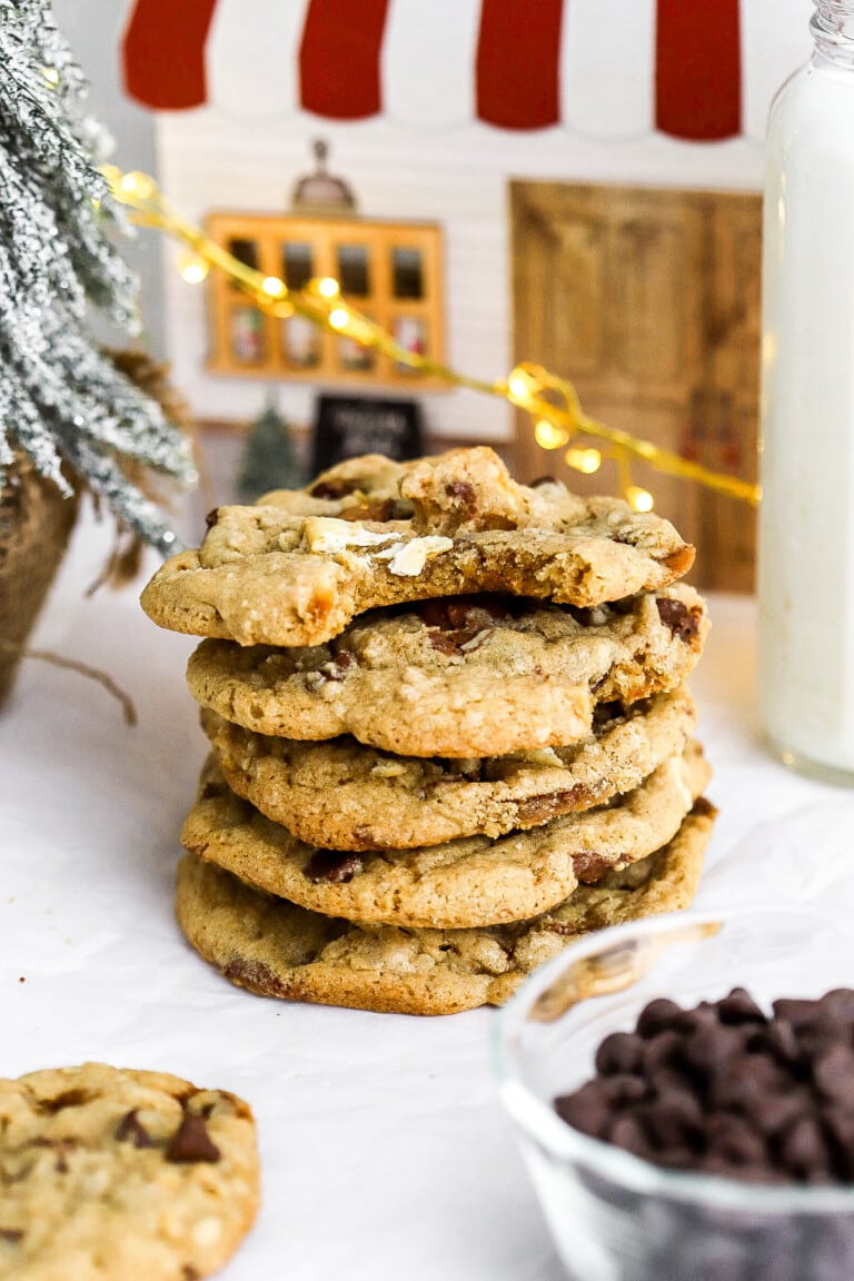 Front facing view of saltine cracker christmas cookies with twinkle lights in the background and chocolate chips in foreground.