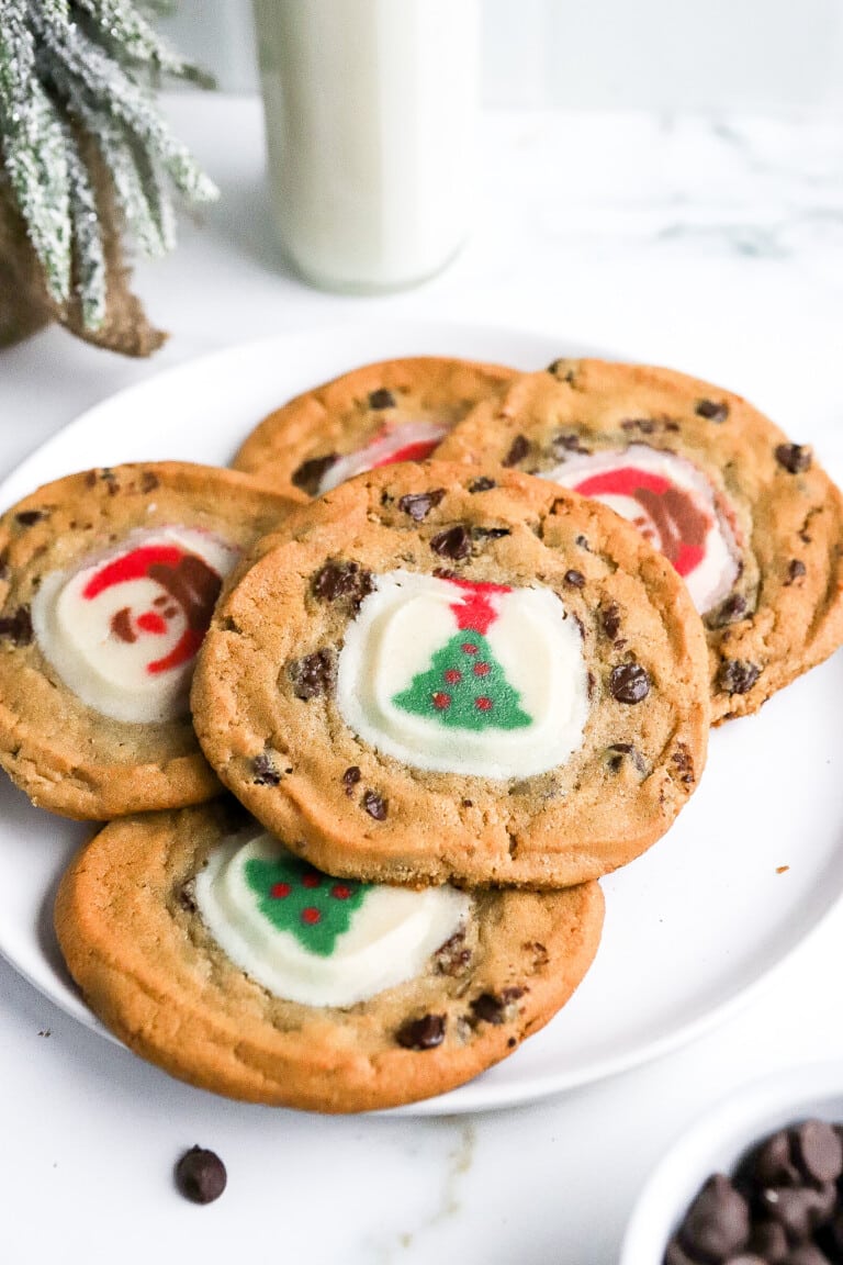 Side angle of 2 layer Christmas cookies with a christmas tree in the background.