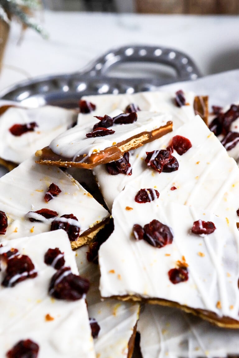 Side angle of cranberry bliss cracker toffee on silver platter.