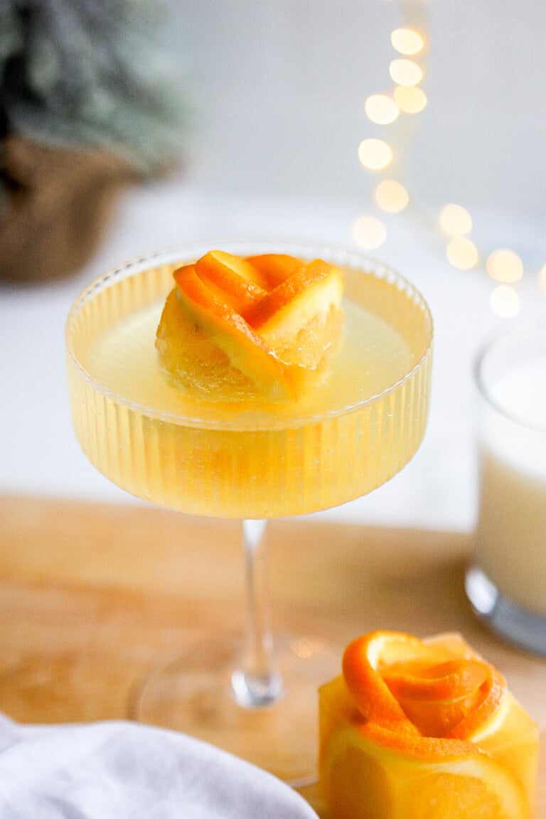 Close up shot of holiday ice cubes for mimosas in a couple glass for christmas morning.