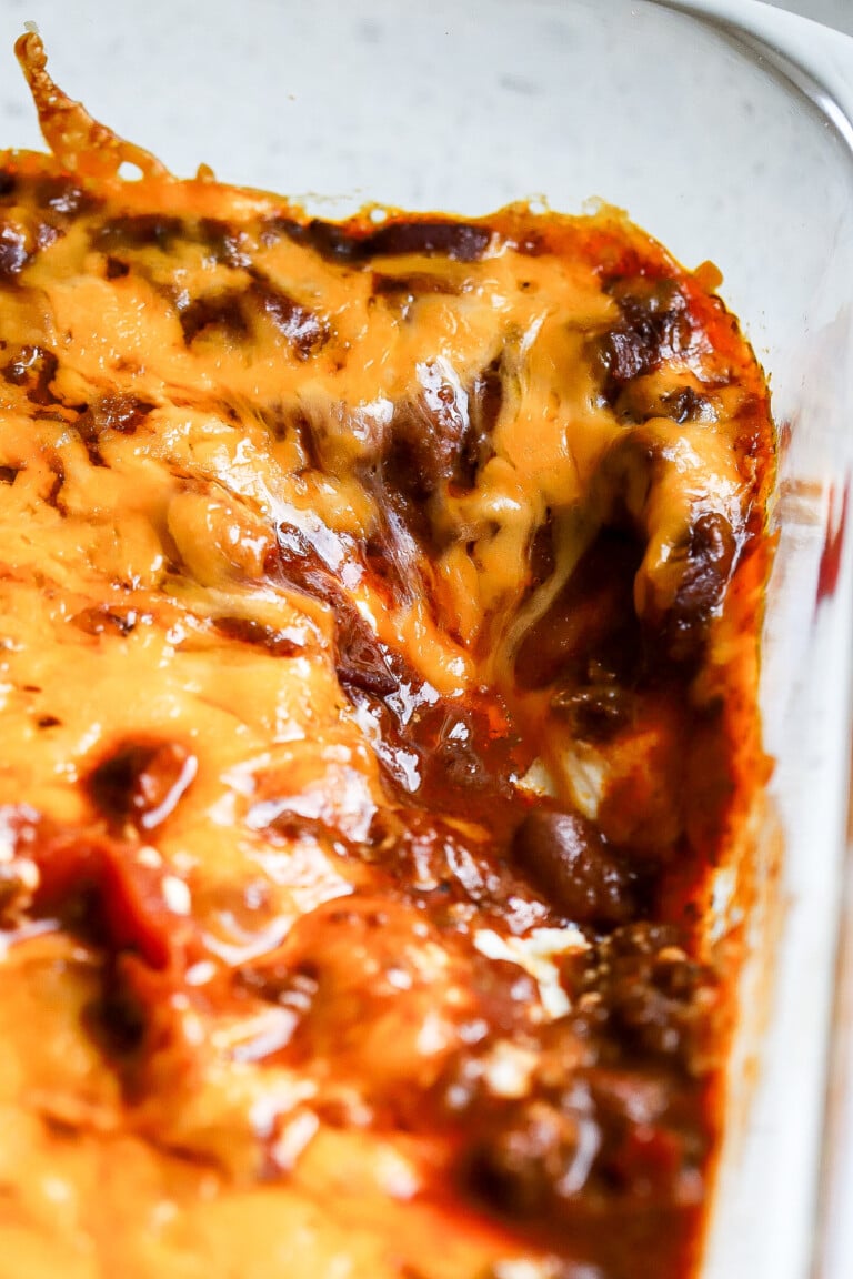 Close up shot of 3-ingredient chili cheese dip with melted cheddar cheese on top.