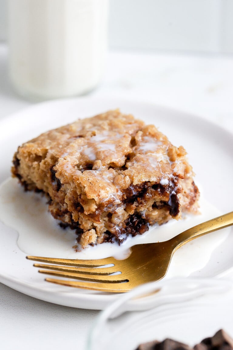 Front view of easy chocolate chip baked oats with milk overtop on a small white plate.