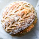 Top down view of sourdough bread loaf with pretty design on it.