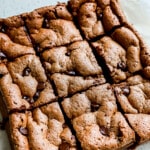 Side view of 9 slices of low calorie brownies on parchment paper.