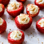 high protein cheesecake stuffed strawberries piped with Greek yogurt filling and graham crumbs