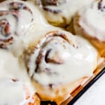 High protein cinnamon rolls with cream cheese frosting in a baking dish