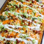 High protein chicken bacon ranch casserole in a 9x13 baking dish topped with melted cheese and crispy bacon