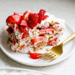 Strawberry icebox cake slice topped with sliced strawberries